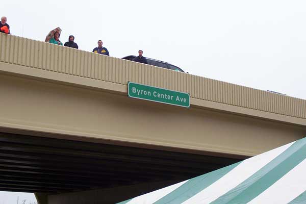 Curious local residents flocked to the Byron Center Ave overpass to watch the festivites from above. Transportation Dept Director Gloria Jeff quipped that these folks were using 'the most expensive and well-built balcony in the state.'