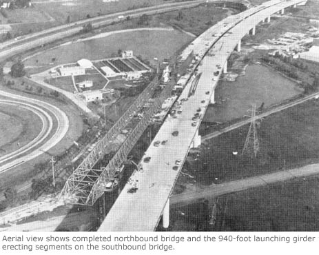 Aerial view shows completed northbound bridge and the 940-foot launching girder erecting segments on the southbound bridge.