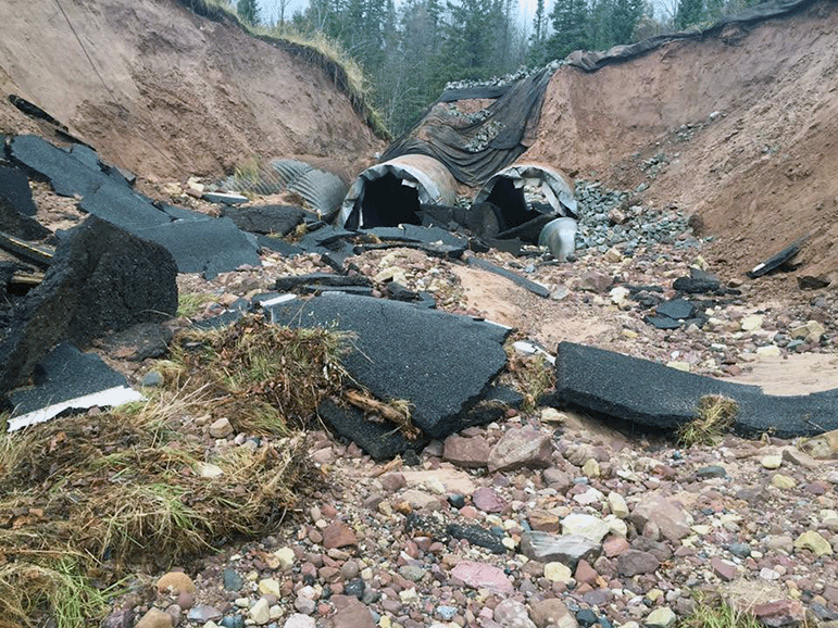 The aftermath of a flooding event on the East Branch of the Chocolay River washing away a 90-foot section of M-94.