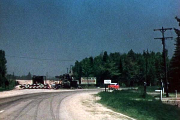 A closer view from the previous image, as US-31 veers to the right from present-day M-108/Nicolet Ave onto present-day Old 31. You can see the massive amount of fill required to bring Nicolet Ave up to the new US-23/US-27 intersection. (1956)