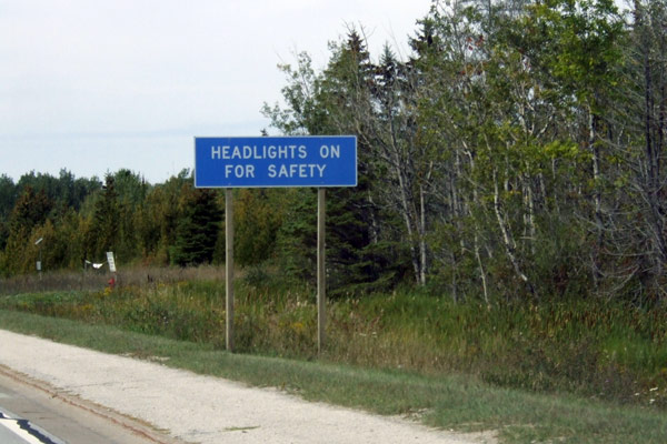 Headlights on for Safety sign on US-2 in St Ignace